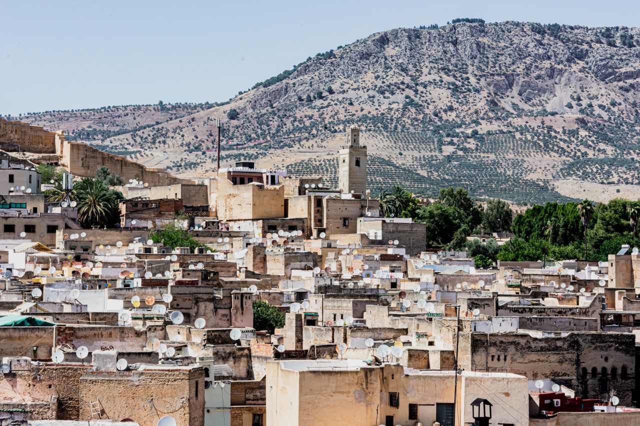Fes medina seen from above with the Atlas Mountains behind