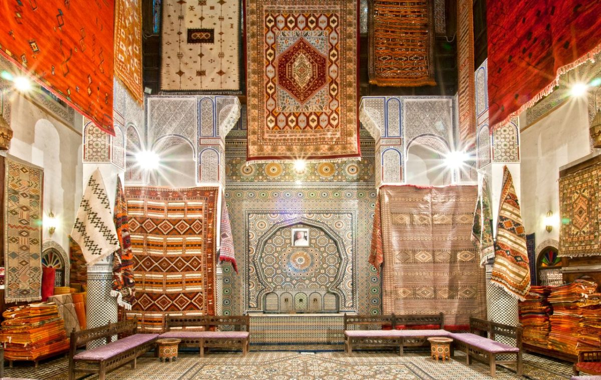Moroccan carpets stacked in a shop in Fes