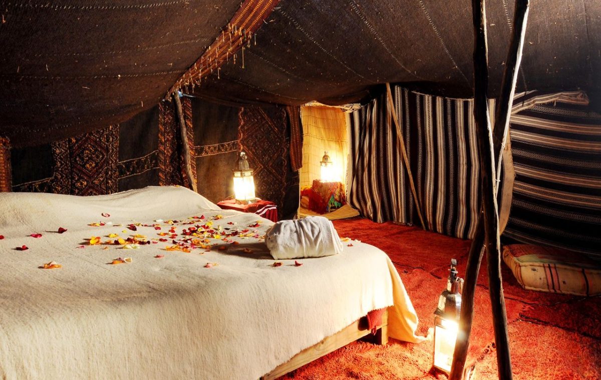 Inside a Berber tent with rugs and lanterns