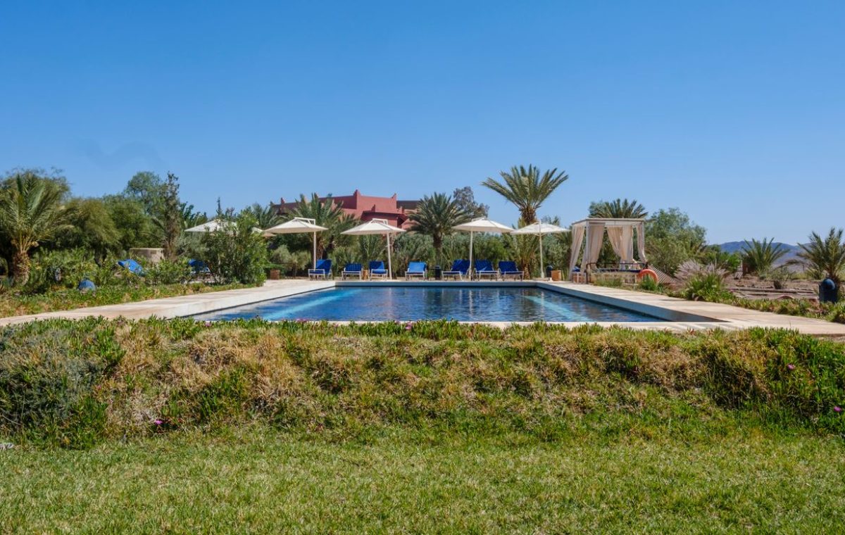 Hotel pool with palm trees in Ouarzazate