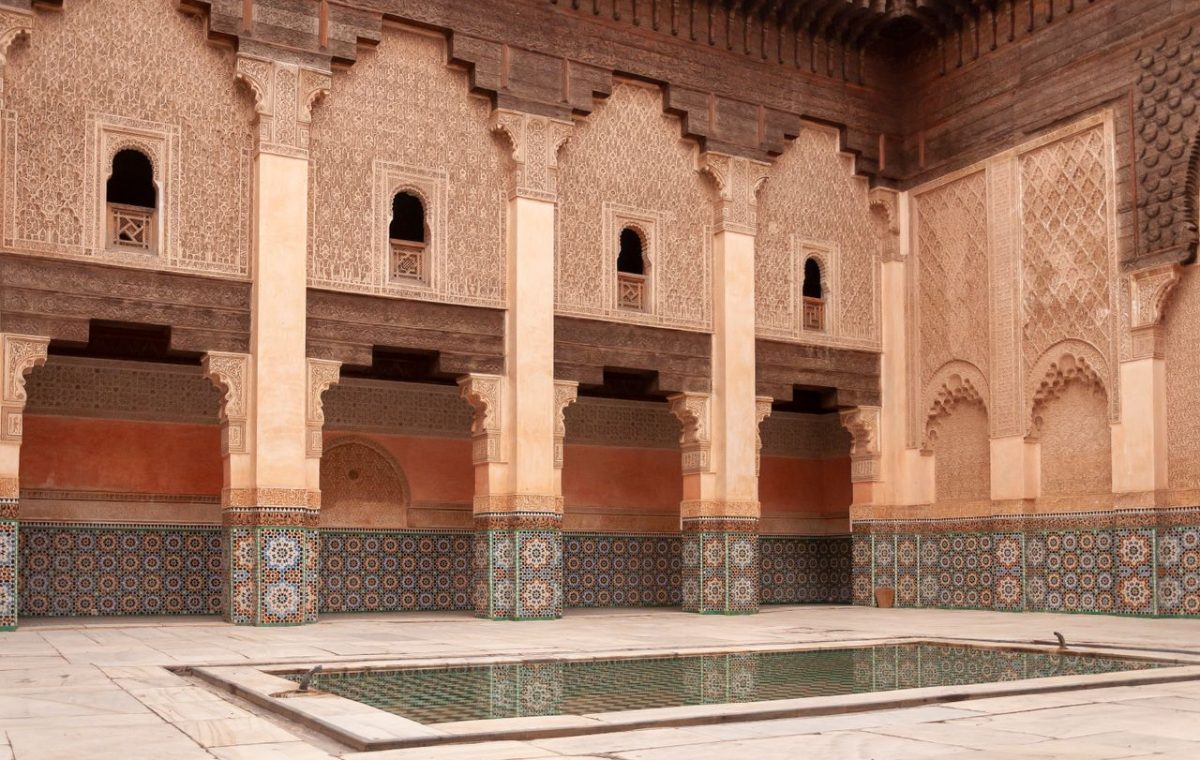 Courtyard of the Ben Youssef Madrasa with carved arches, on a Marrakech and Sahara tour